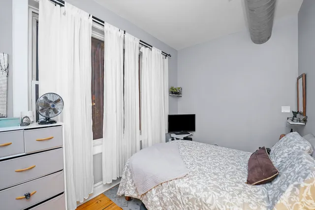 a bedroom with a bed and a dresser