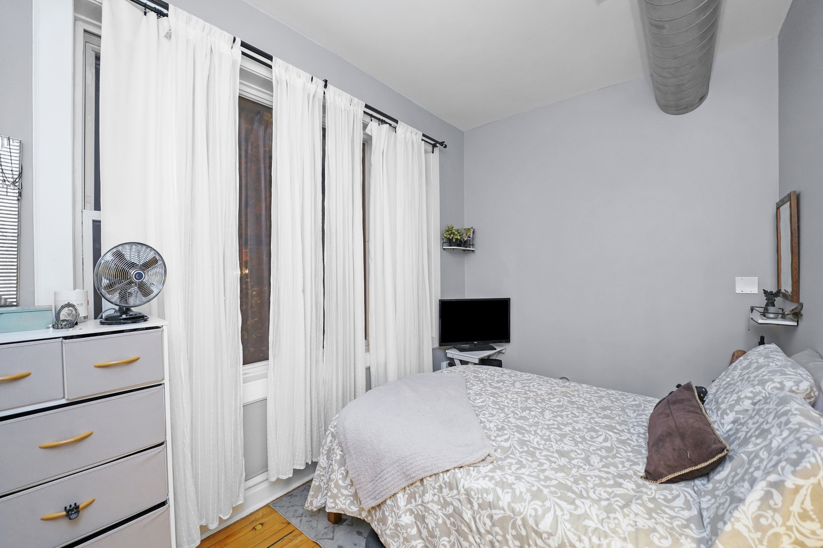 4363 North Lincoln Avenue Chicago, IL 60618 - Photo 22 of 34 a bedroom with a bed and a dresser