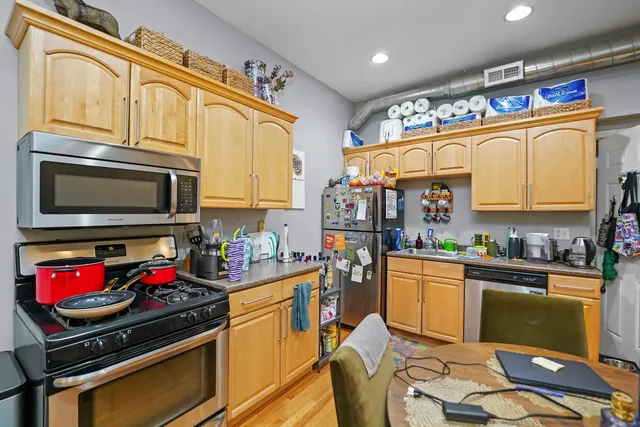 a kitchen with stainless steel appliances granite countertop a stove and cabinets