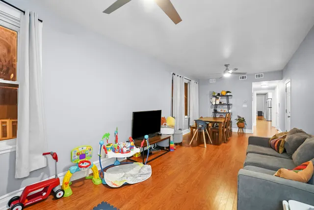 a playing room with furniture and a flat screen tv