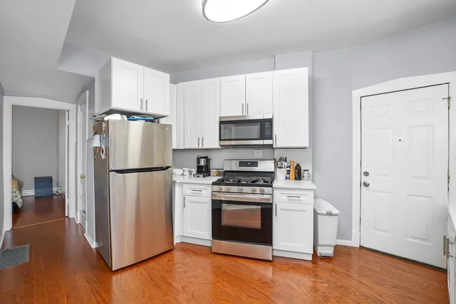 a kitchen with a refrigerator sink and stove