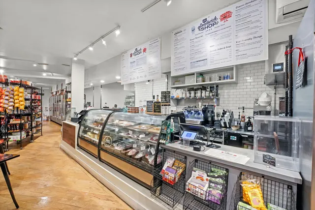 a large kitchen with stainless steel appliances granite countertop a stove and cabinets