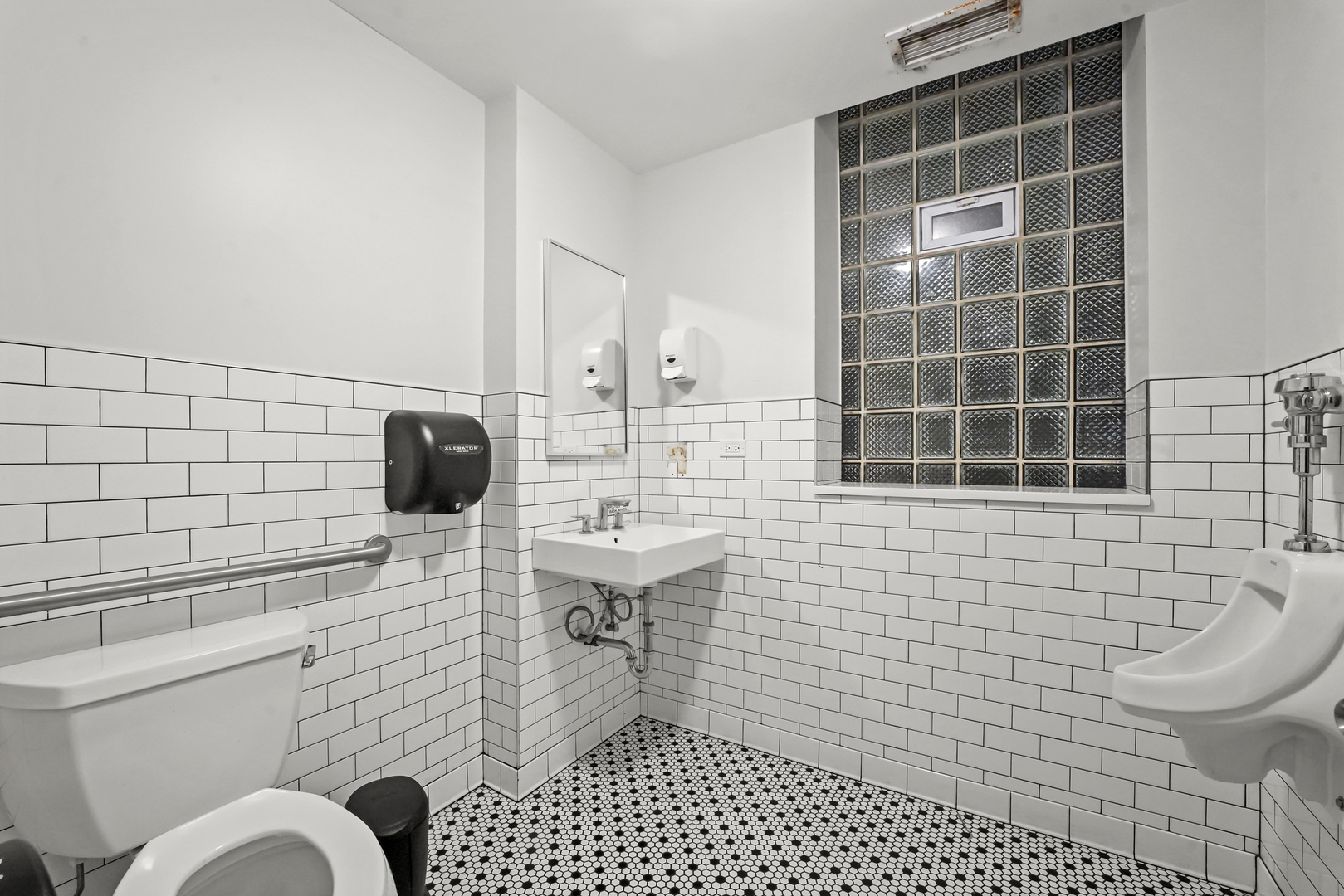 4363 North Lincoln Avenue Chicago, IL 60618 - Photo 7 of 34 a bathroom with a toilet a sink and mirror