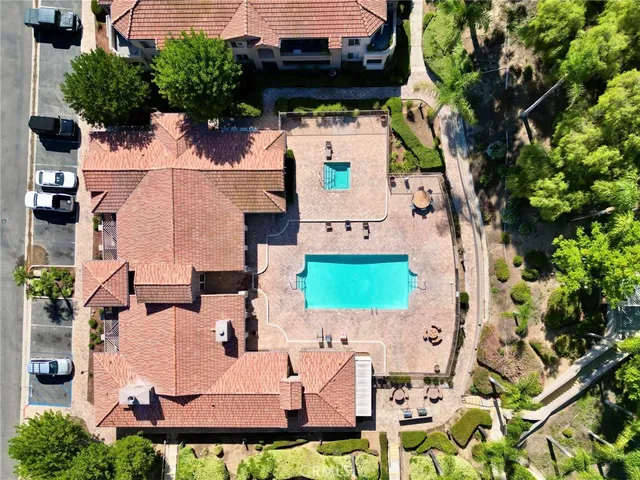 an aerial view of a house with a garden and lake view