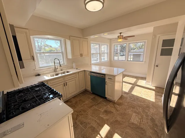 a kitchen with a sink stove and cabinets