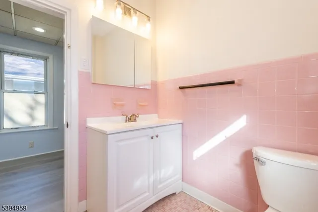 a bathroom with a sink a toilet and a mirror