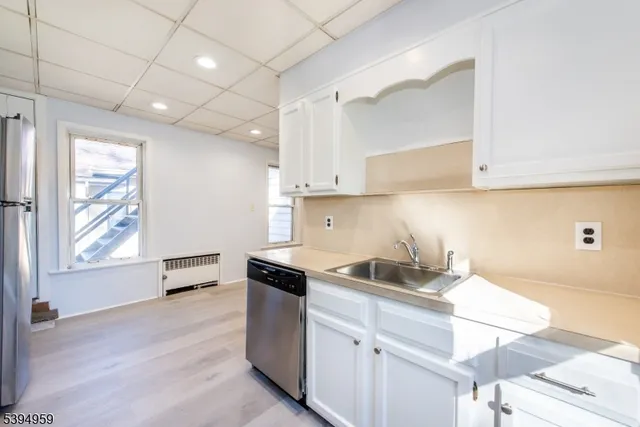 a kitchen with granite countertop a sink and a stove top oven