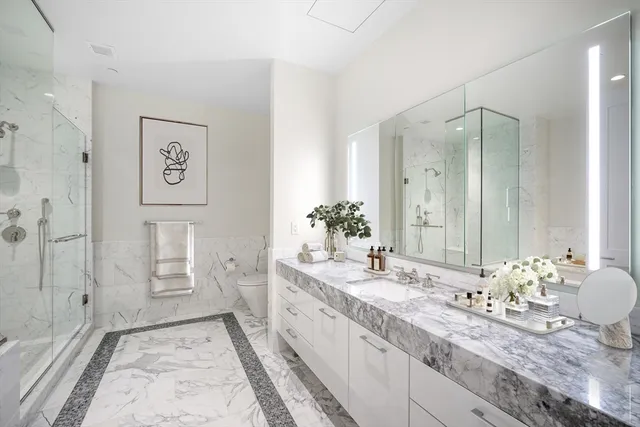 a spacious bathroom with a granite countertop sink and a mirror