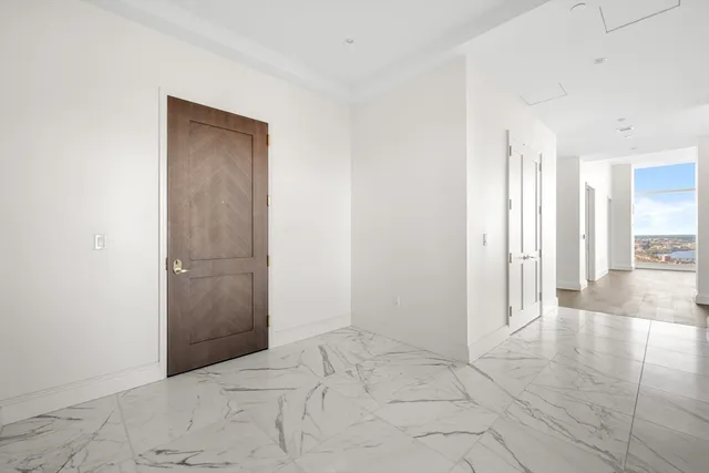 an empty room with entrance and windows