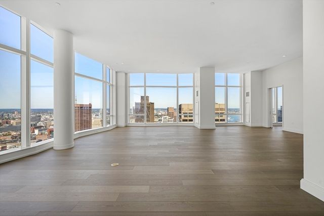 a view of empty room with floor to ceiling window and floor