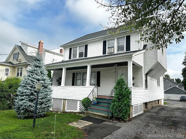 118 Colonial Road, Unit 1 Stamford, CT 06906 - Photo 1 of 1 a front view of a house with a garden