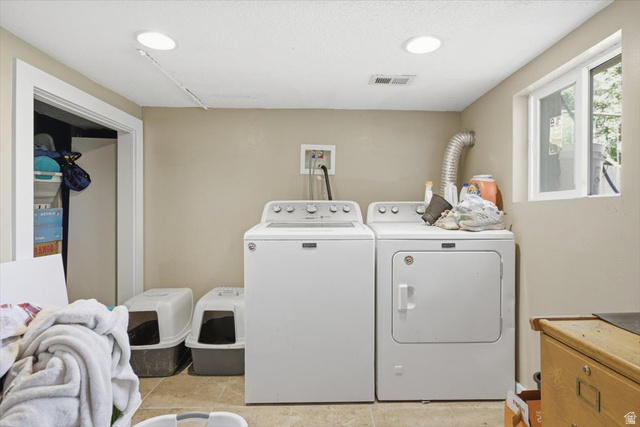565 East 800 North Logan, UT 84321 - Photo 16 of 27 Dedicated laundry area with tile flooring, a window offering natural light, and recessed ceiling lighting