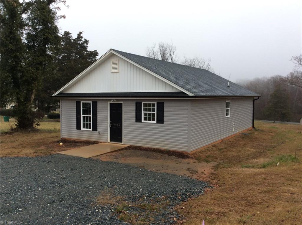 7739 Pine Street Rural Hall, NC 27045 - Photo 11 of 33 Front Right View: Here we can see the low maintenance vinyl exterior and the gravel parking area right out front and the concrete sidewalk right up to the front door.