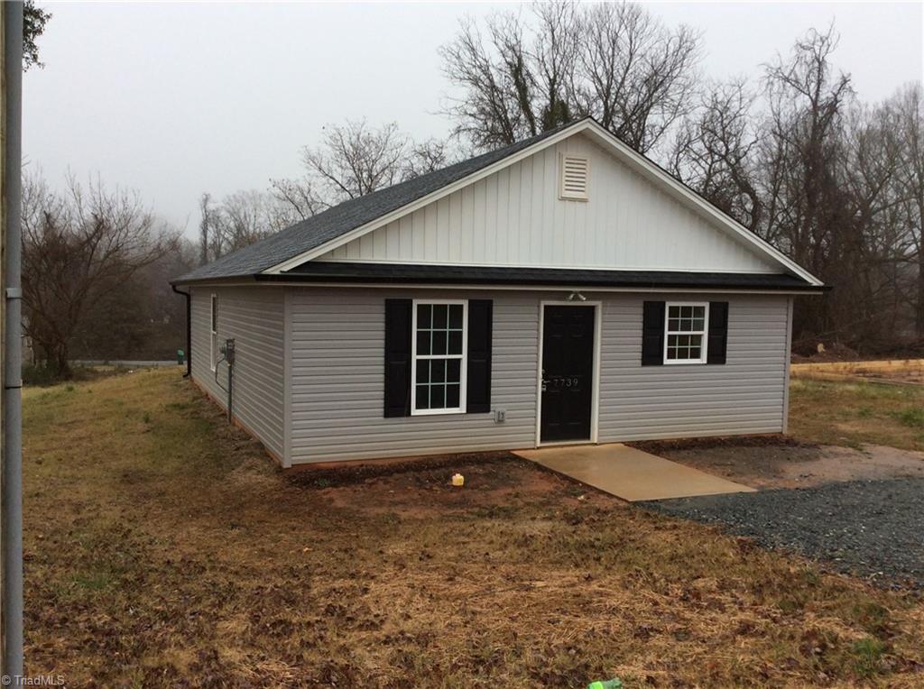 7739 Pine Street Rural Hall, NC 27045 - Photo 12 of 33 Front Left View: Here we can see the low maintenance vinyl exterior and the gravel parking area right out front and the concrete sidewalk right up to the front door.