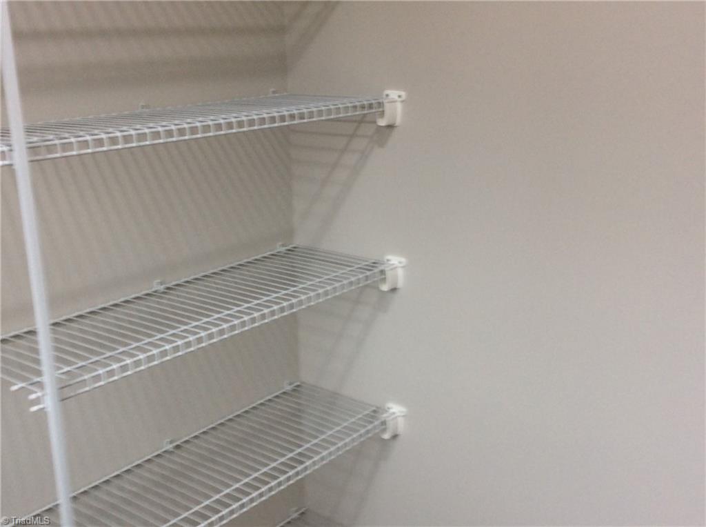 7739 Pine Street Rural Hall, NC 27045 - Photo 32 of 33 Laundry Room: Features include vinyl plank flooring for easy cleaning, all the hookups for your washer and dryer, a window for natural lighting and wire racks for your cleaning products.