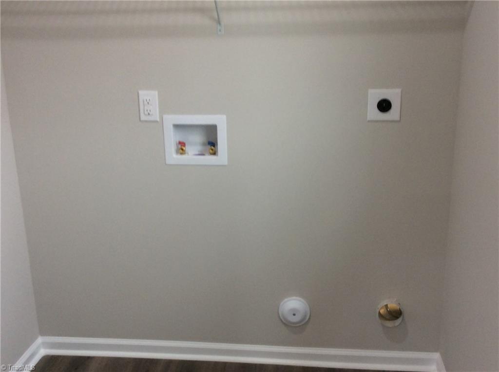 7739 Pine Street Rural Hall, NC 27045 - Photo 10 of 33 Laundry Room: Features include vinyl plank flooring for easy cleaning, all the hookups for your washer and dryer, a window for natural lighting and wire racks for your cleaning products.