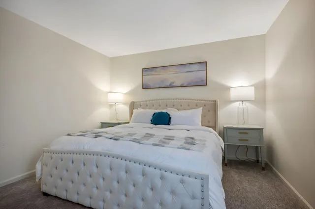 a bedroom with a bed and a lamp