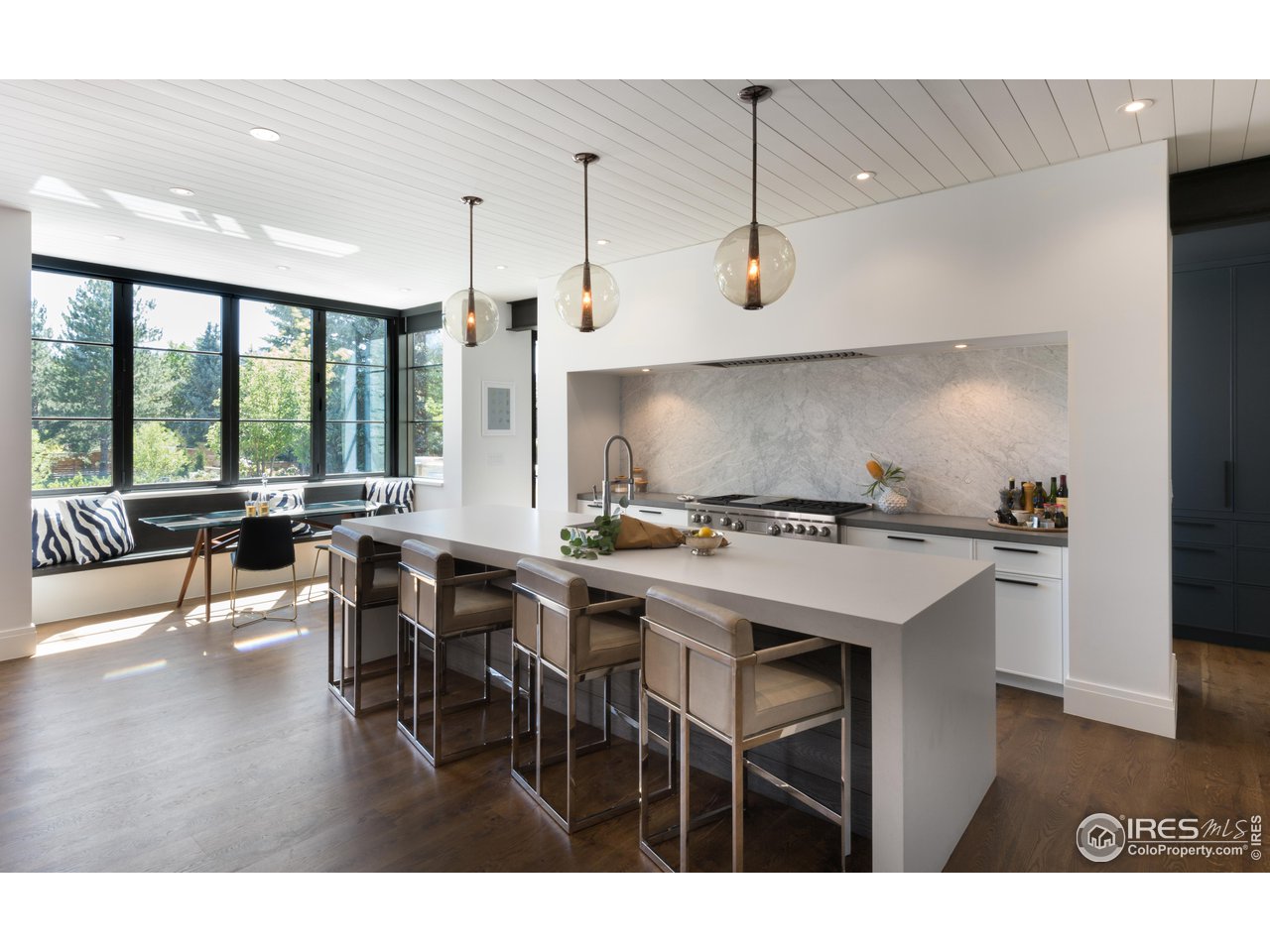 2260 Meadow Avenue Boulder, CO 80304 - Photo 9 of 21 a kitchen with a table chairs and white cabinets
