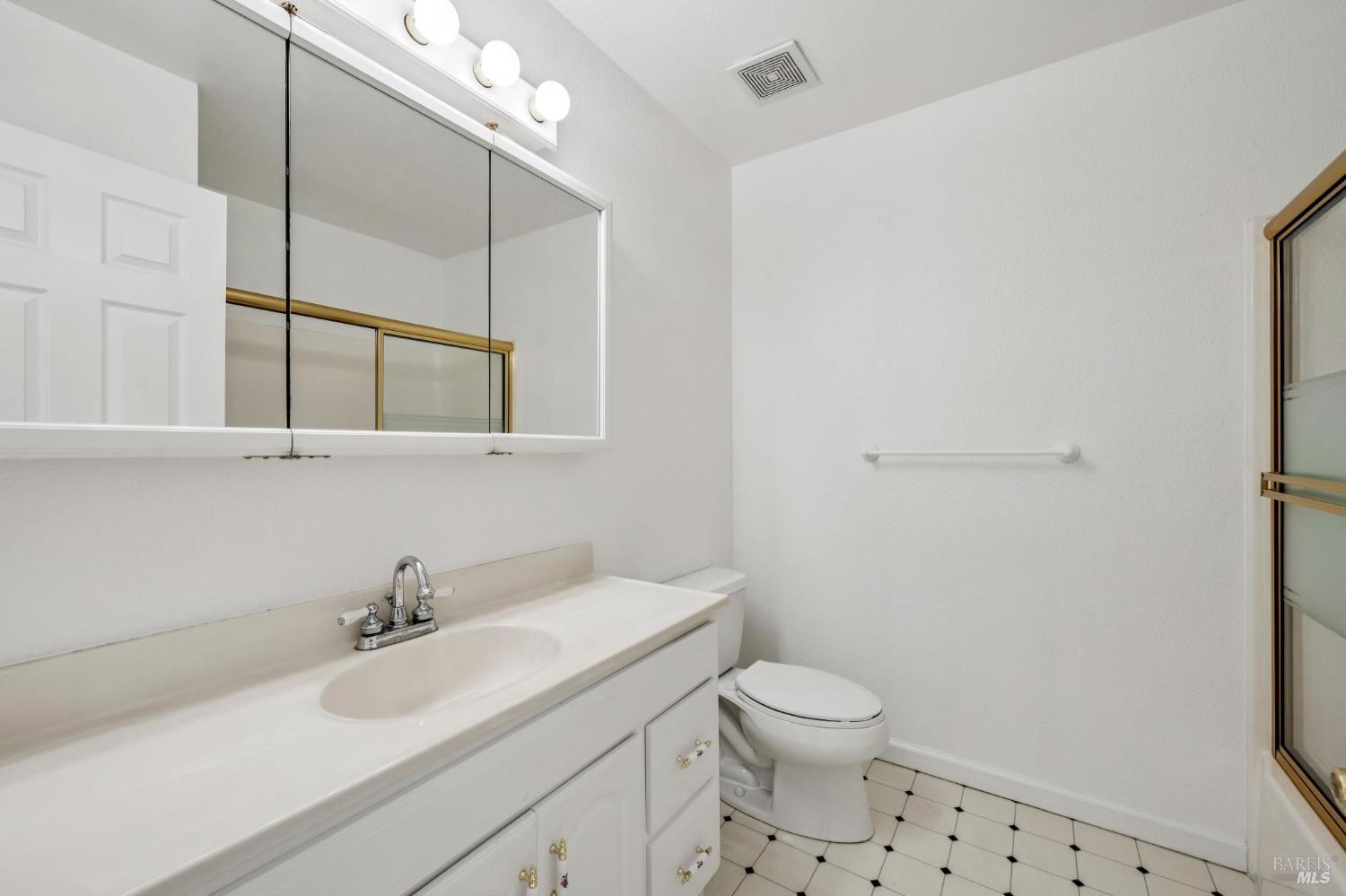 4987 Fern Place Rohnert Park, CA 94928 - Photo 30 of 54 a bathroom with a sink a toilet and a mirror