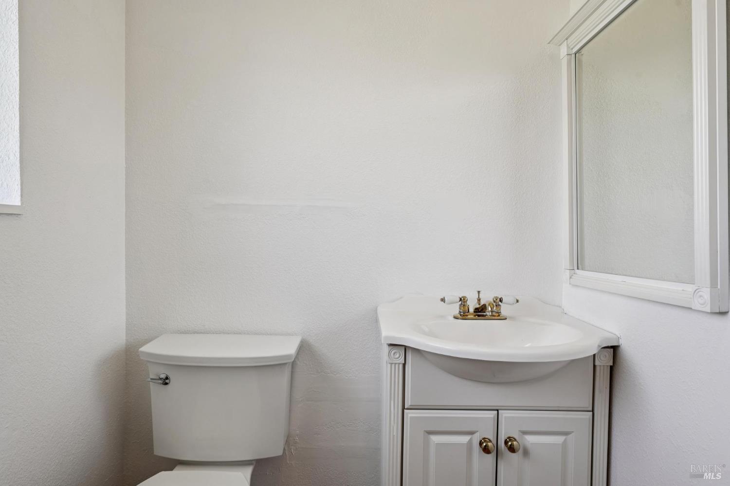 4987 Fern Place Rohnert Park, CA 94928 - Photo 40 of 54 a bathroom with a sink a toilet and mirror