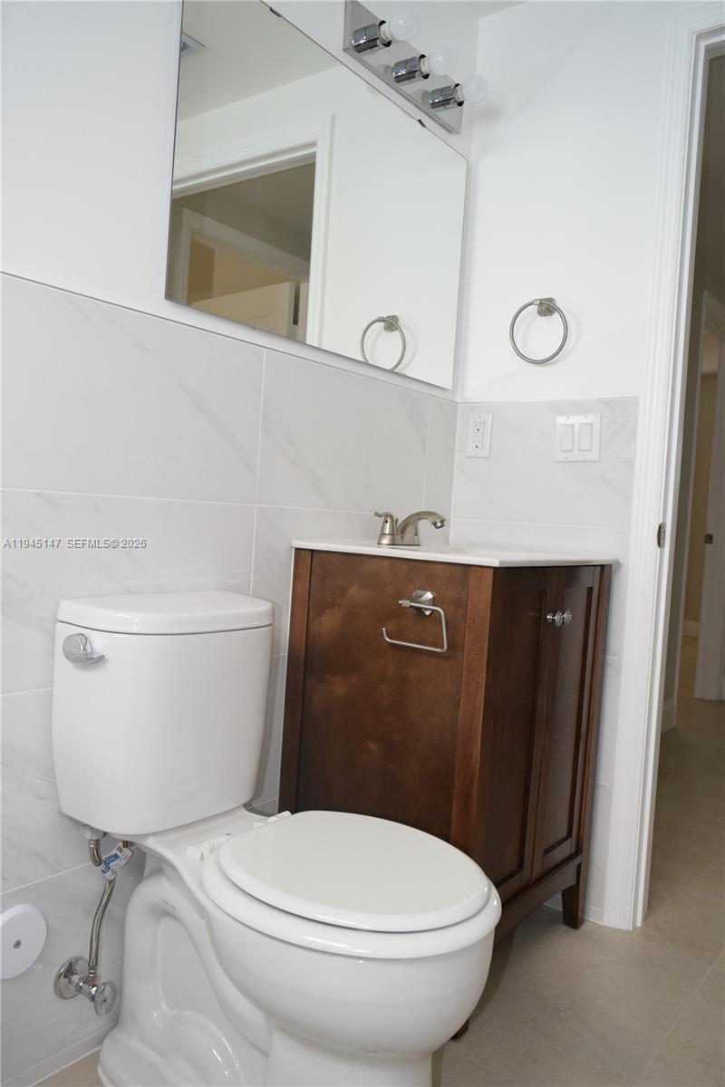 447 Southwest 78th Court Miami, FL 33144 - Photo 11 of 11 a bathroom with a toilet a sink and mirror