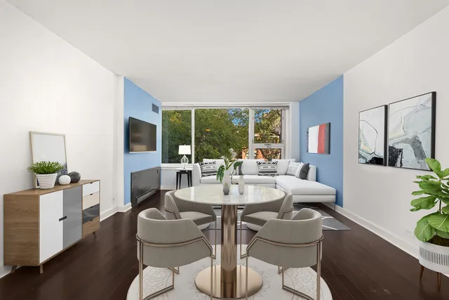 a dining room with furniture wooden floor and a chandelier