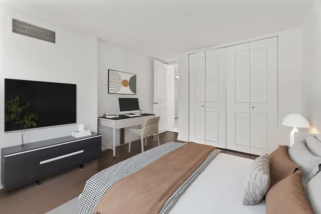 a bedroom with a bed and a flat screen tv