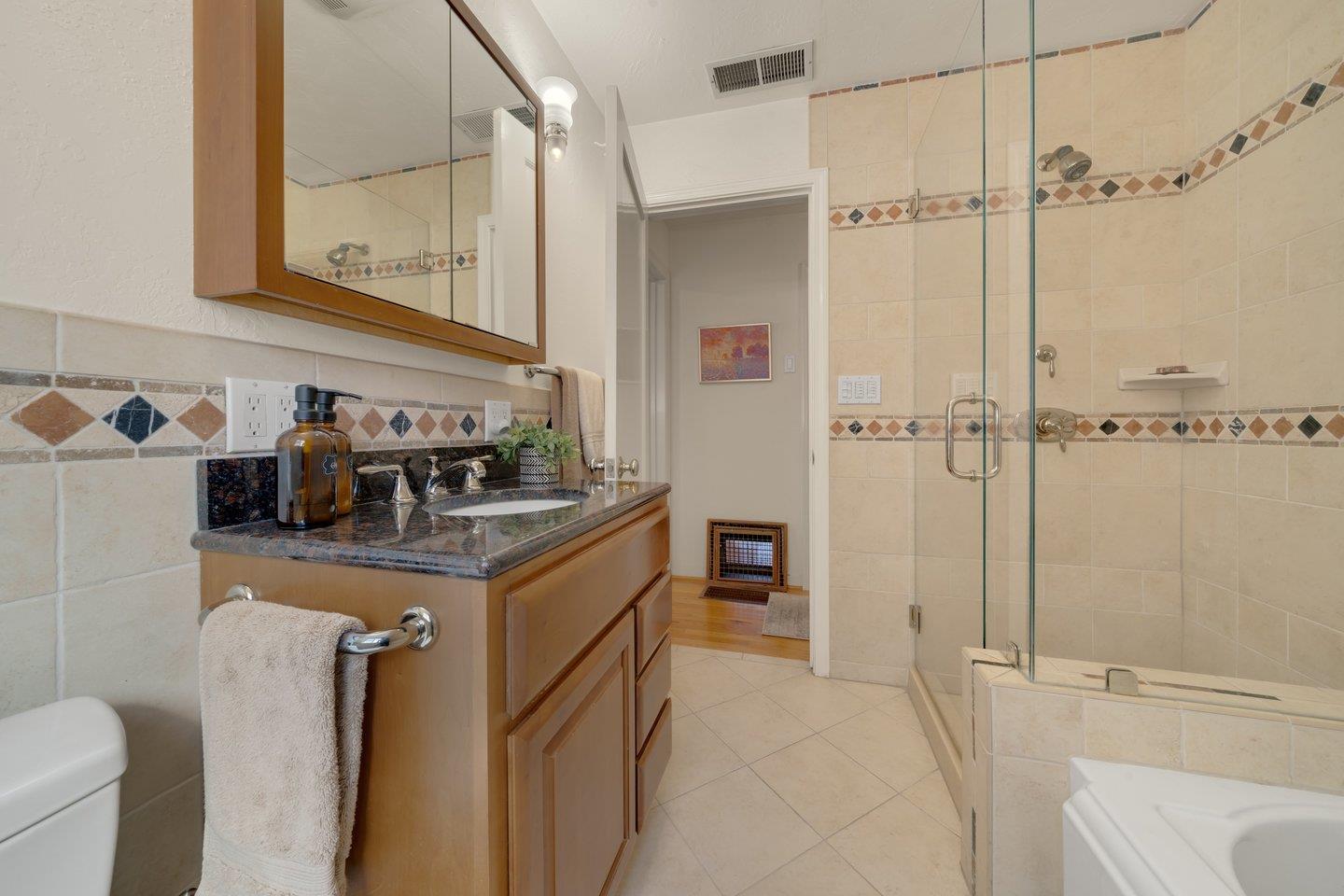 78 Cherry Lane Campbell, CA 95008 - Photo 33 of 49 a bathroom with a granite countertop sink a toilet and shower