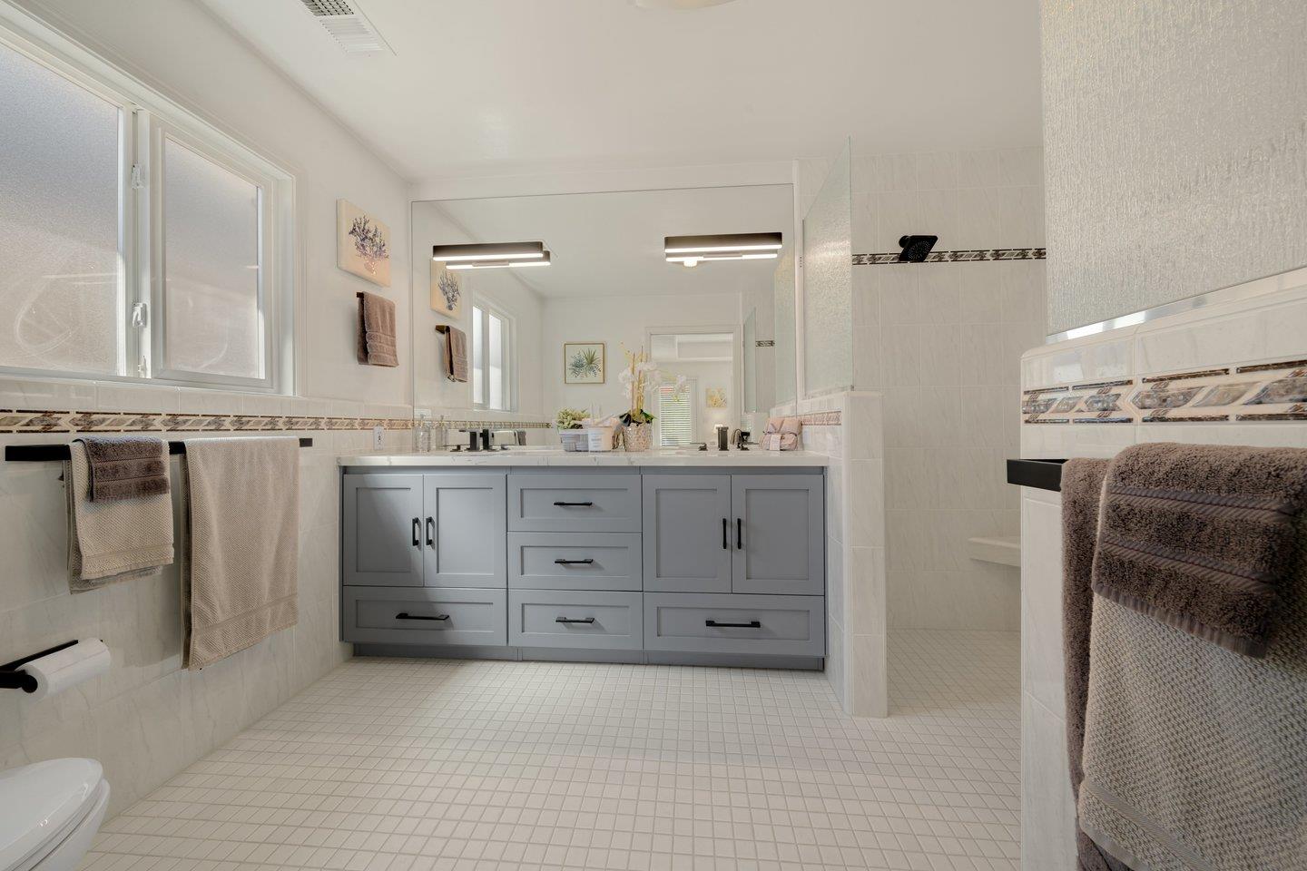 78 Cherry Lane Campbell, CA 95008 - Photo 40 of 49 a spacious bathroom with a granite countertop sink mirror and toilet
