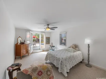 a bedroom with a bed couch and a window