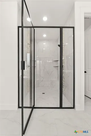 a bathroom with a glass shower door