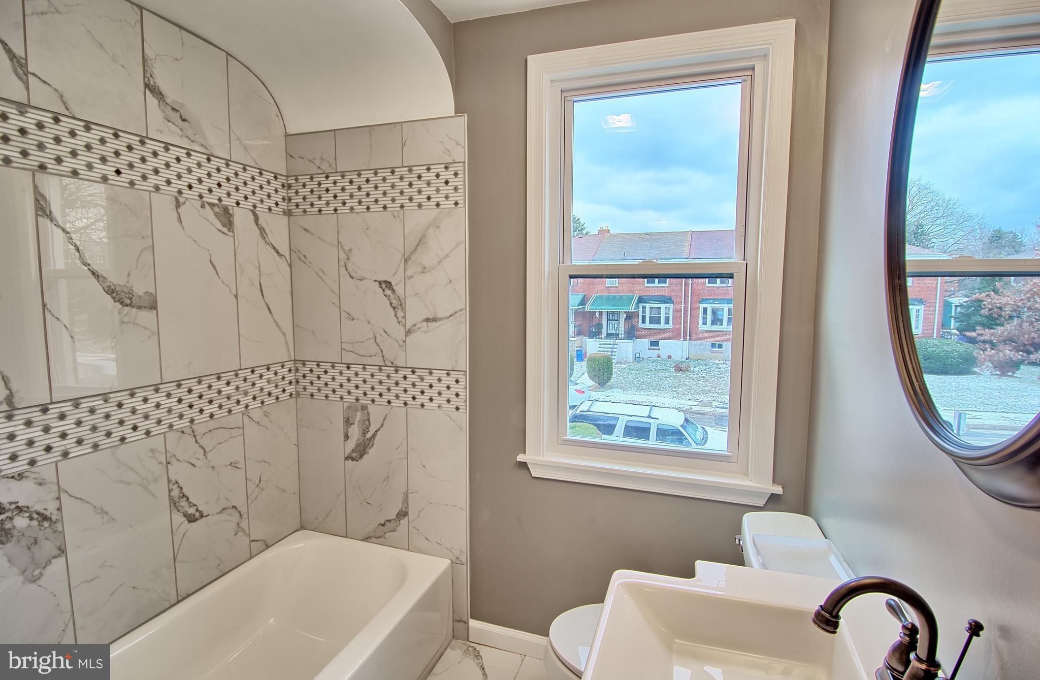 719 Stamford Road Baltimore, MD 21229 - Photo 14 of 29 Fully renovated bath with custom tile and mosaic