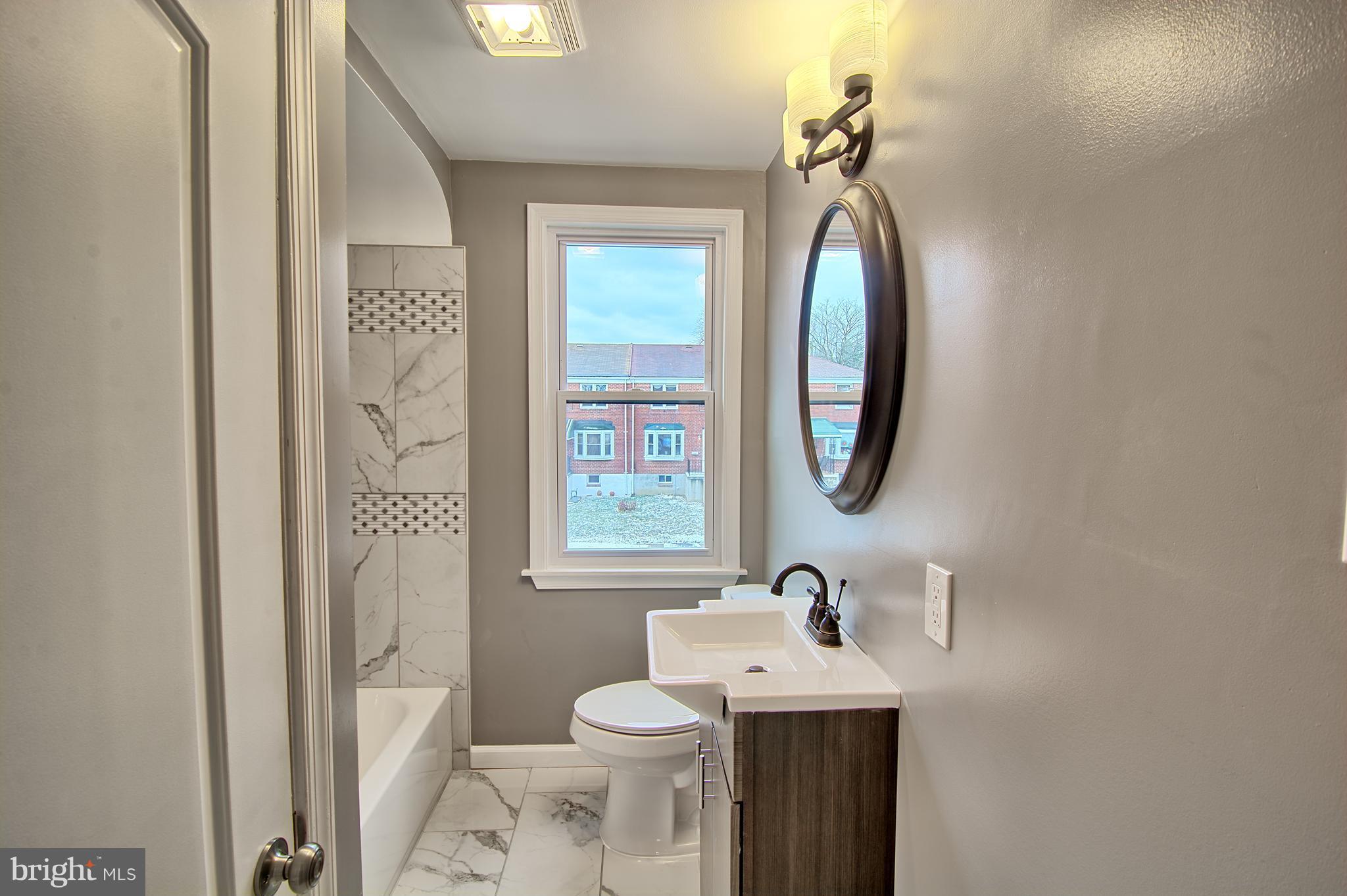 719 Stamford Road Baltimore, MD 21229 - Photo 15 of 29 Upstairs Bathroom,custom tile, new vanity and tub