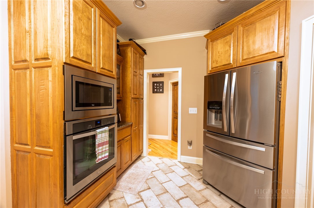 126 Moore Mountain Road Vilas, NC 28692 - Photo 17 of 41 a kitchen with stainless steel appliances granite countertop a refrigerator and a stove top oven