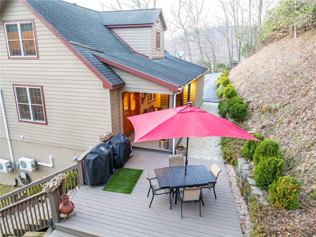 126 Moore Mountain Road Vilas, NC 28692 - Photo 2 of 41 a view of house with wooden deck and outdoor seating