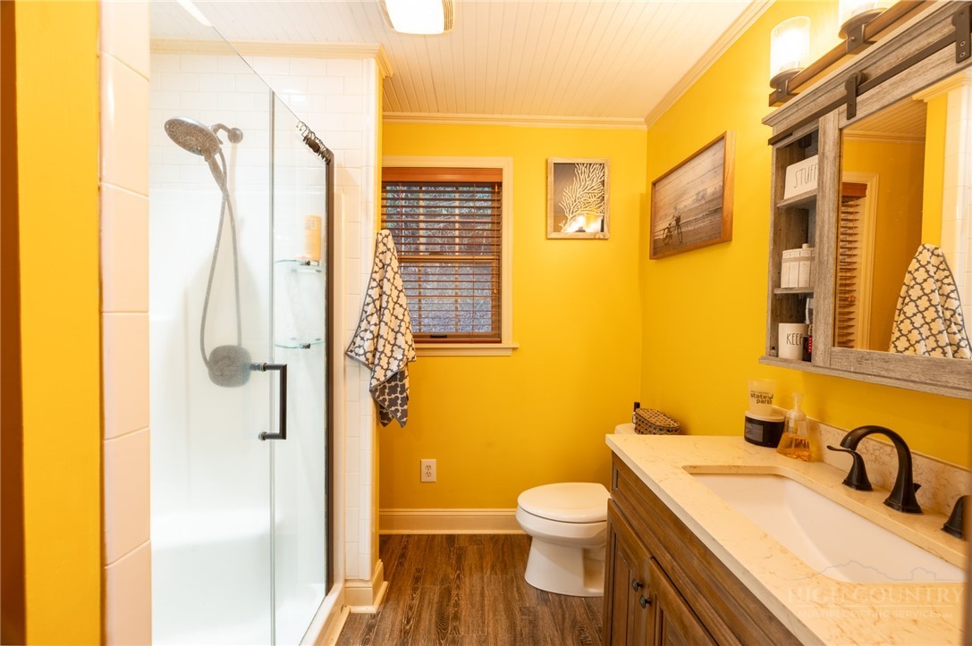 126 Moore Mountain Road Vilas, NC 28692 - Photo 21 of 41 a bathroom with a sink a toilet and shower