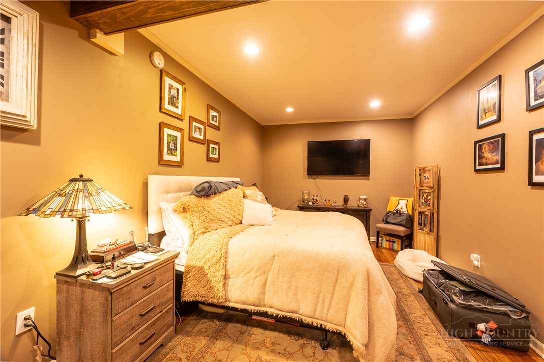 126 Moore Mountain Road Vilas, NC 28692 - Photo 24 of 41 a bed room with a bed and a tv