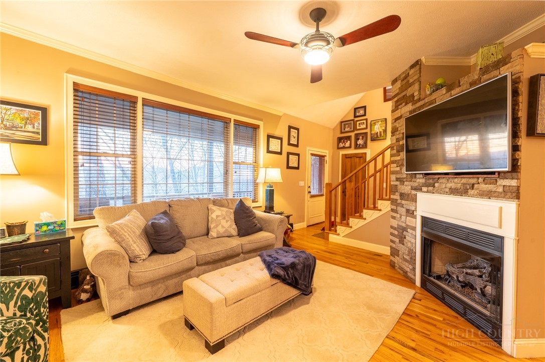 126 Moore Mountain Road Vilas, NC 28692 - Photo 10 of 41 a living room with furniture a flat screen tv and a fireplace