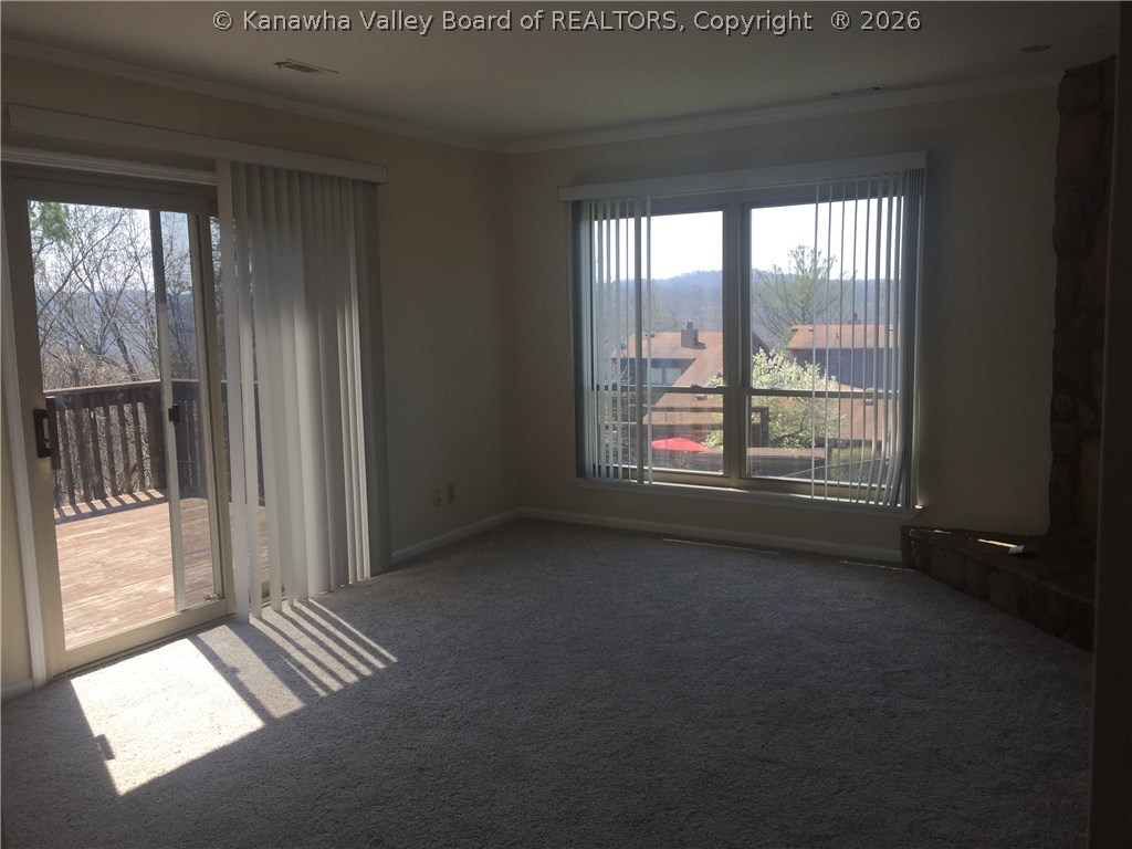 402 Powderhorn Road Charleston, WV 25314 - Photo 5 of 29 living room showing windows and patio doors to deck.