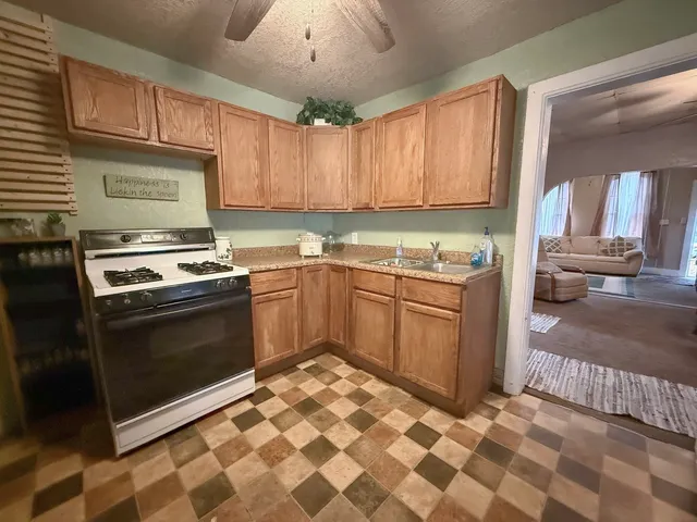 a kitchen with a stove a sink and a microwave