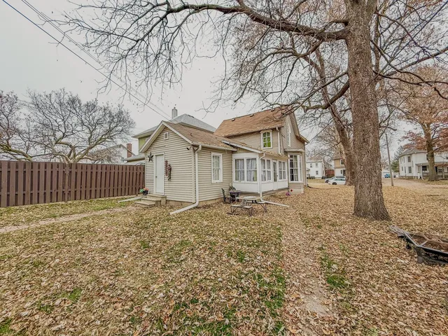 a white house that has a tree in front of it