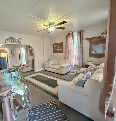 a living room with furniture and a chandelier