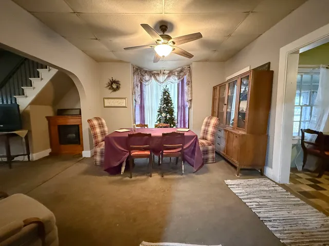 a living room with furniture a fireplace and a chandelier
