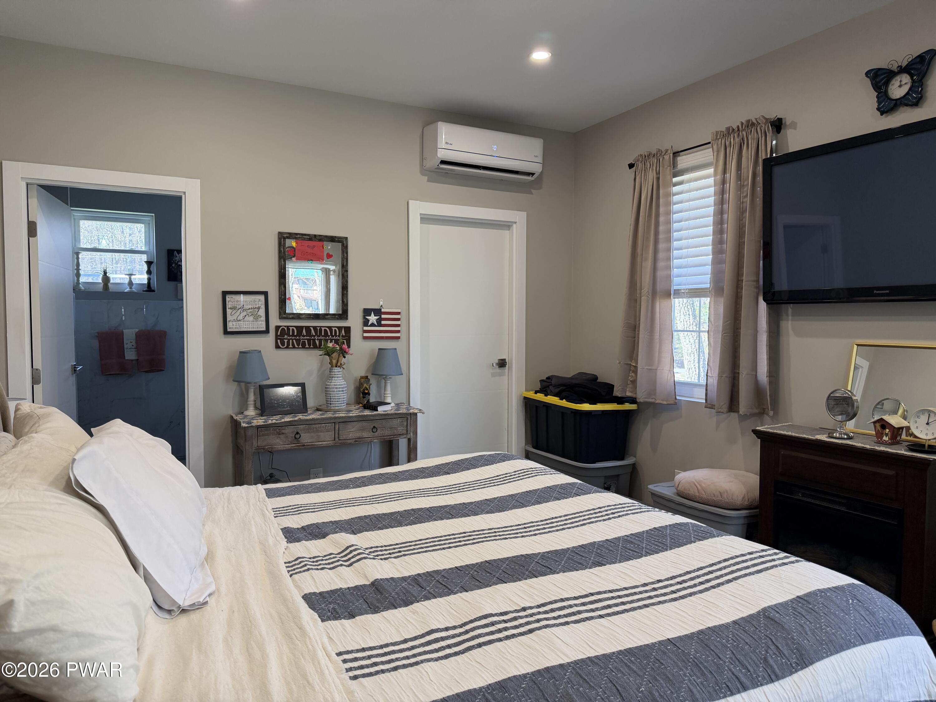 801 Maple Ridge Court Hawley, PA 18428 - Photo 22 of 55 a bedroom with a bed and a flat screen tv