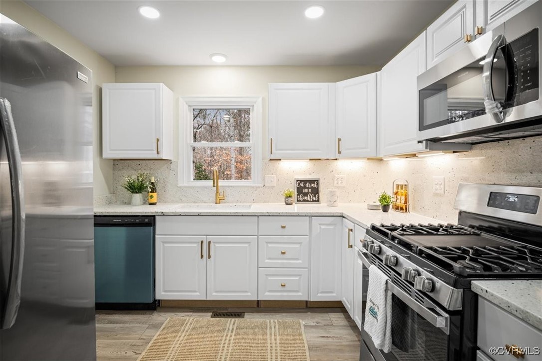 6920 Belmont Road Chesterfield, VA 23832 - Photo 19 of 50 Kitchen featuring white cabinets, light hardwood /