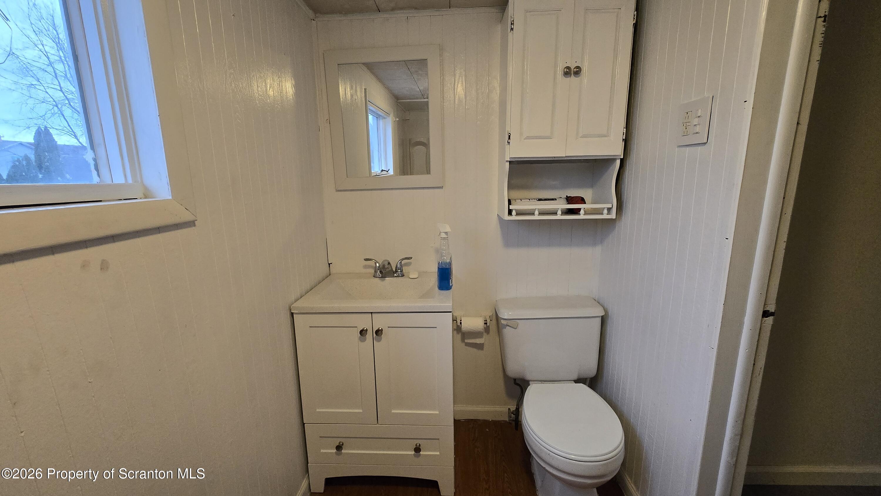 1026 Meade Avenue Scranton, PA 18508 - Photo 4 of 12 a bathroom with a toilet a sink and a window