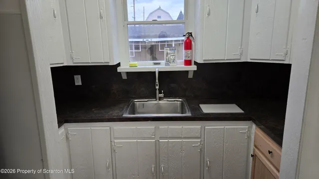 a bathroom with a sink and cabinets