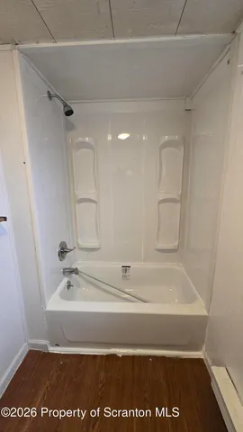 an empty room with wooden floor and closet