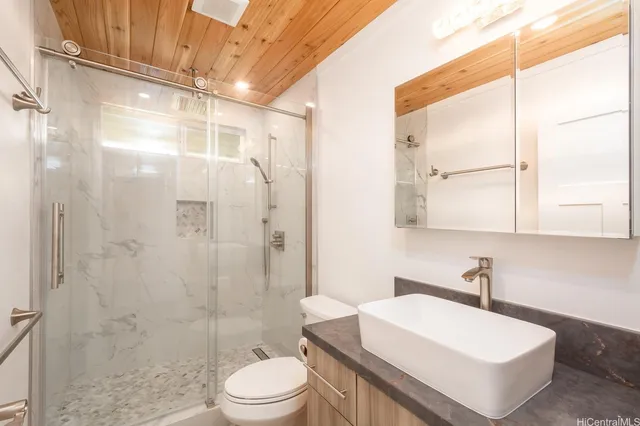 a bathroom with a sink toilet and shower