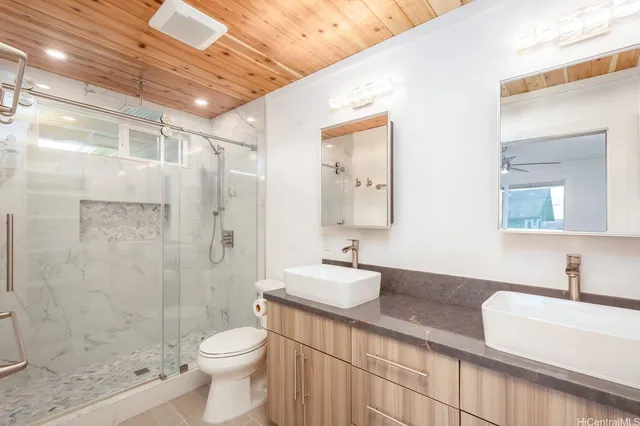 a bathroom with a sink a toilet and shower